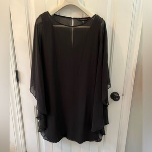 Black cocktail dress with sheer overlay